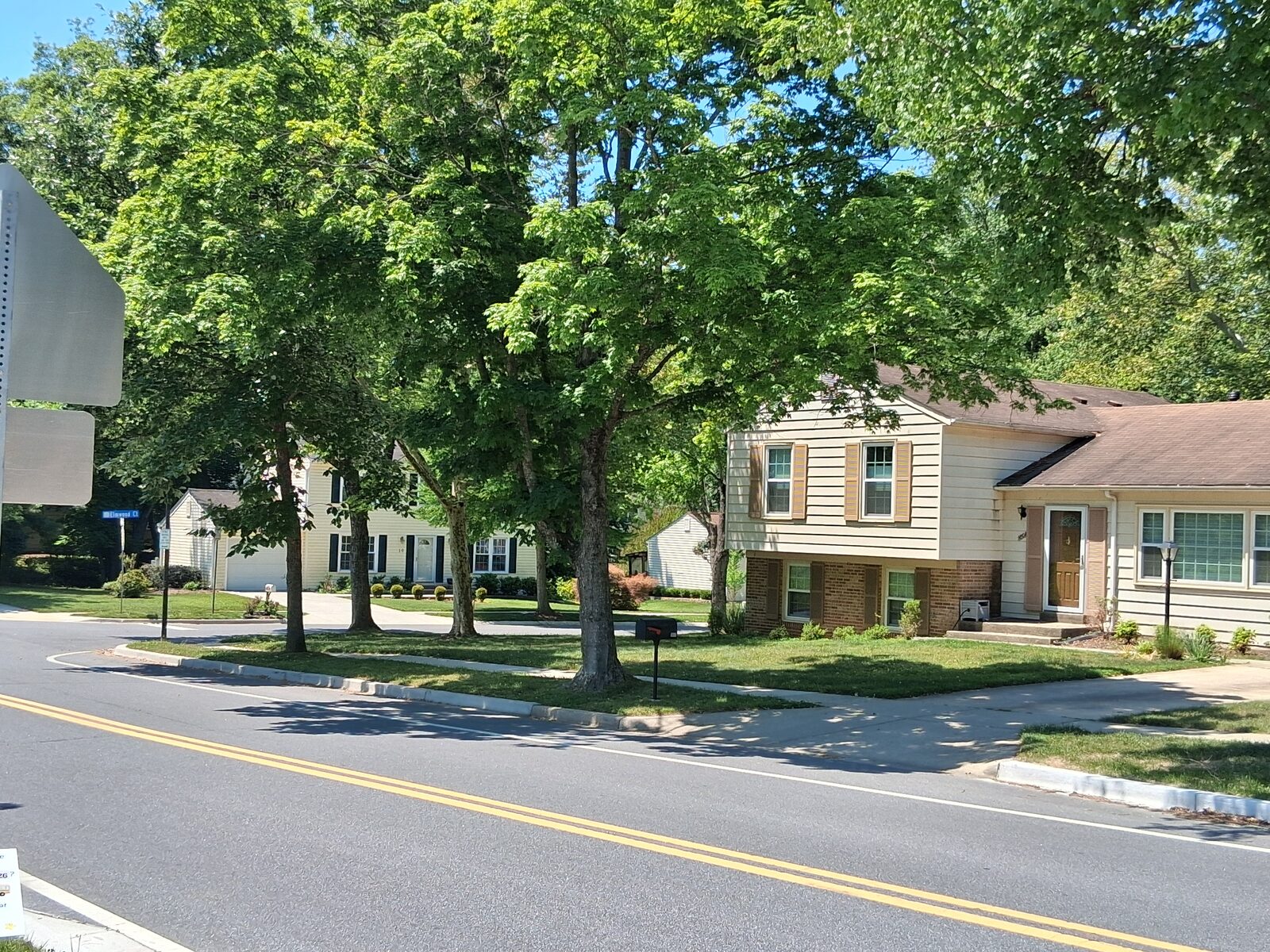 Tree-lined residential street with colonial-style homes in Fallsmead, Rockville